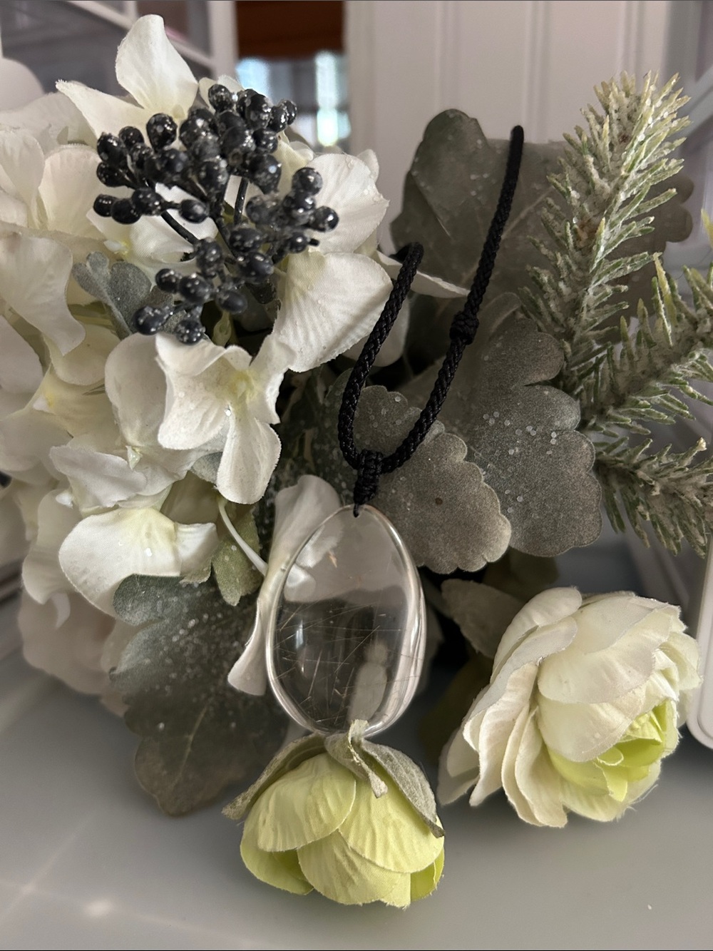 Clear Oval Pendant Necklace with Black Cord and Pale Green Flower Accent